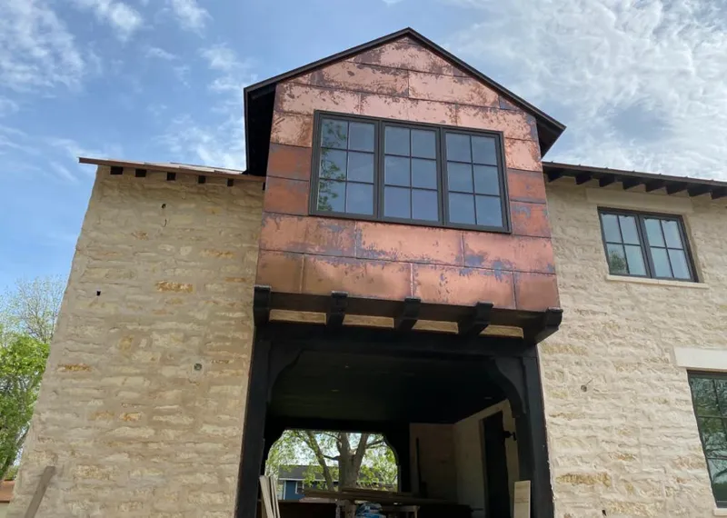 Copper metal panel facade on a stone building for Skylight Installation in St. Clair Shores